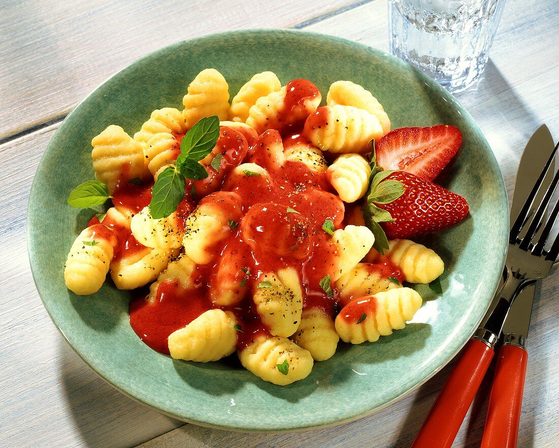 Gnocchi with strawberry sauce and mint leaves