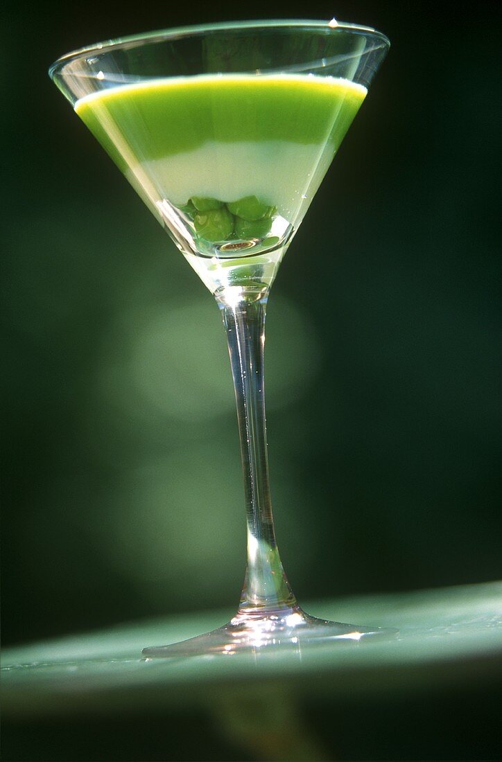 Savoury vegetable cream with peas in a glass