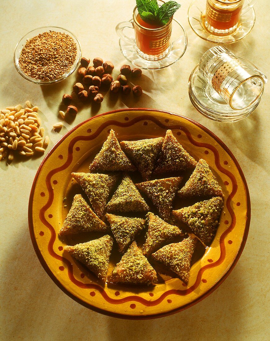 Tunisian puff pastry nut triangles with chopped pistachios