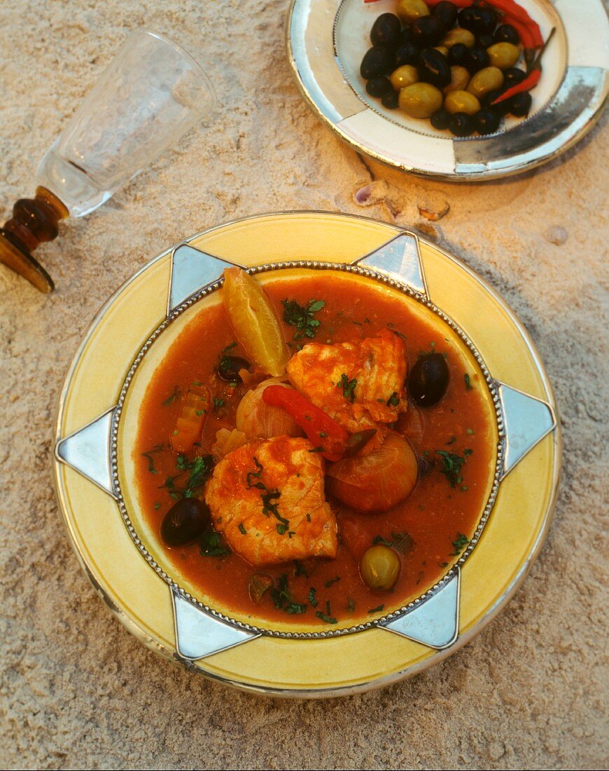 Tunisian angelshark with vegetables in tomato sauce; olives