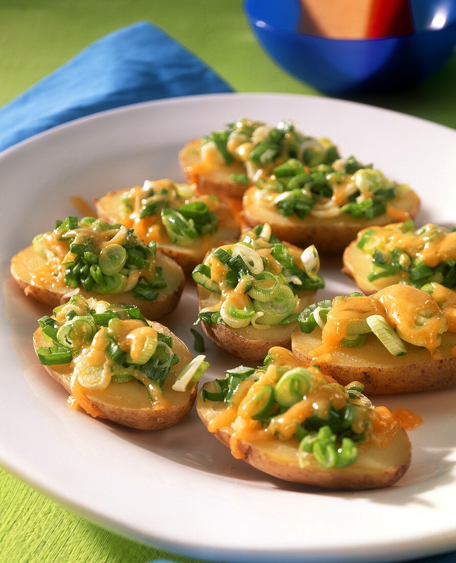 Baked potato skins with cheese and spring onions