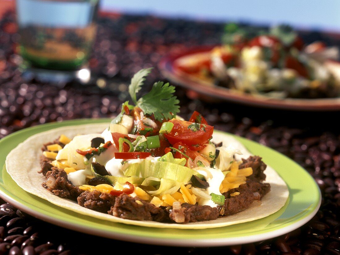 Tortillas with baked beans, cheese and sour cream