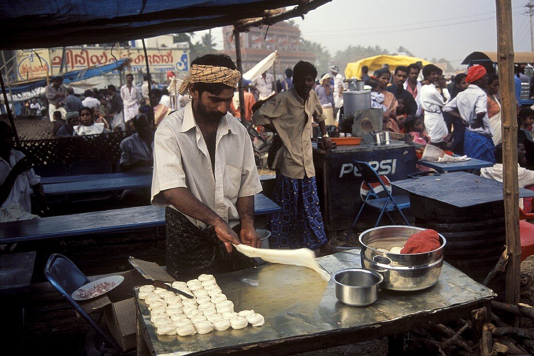 Indian man preparing paratha at the market