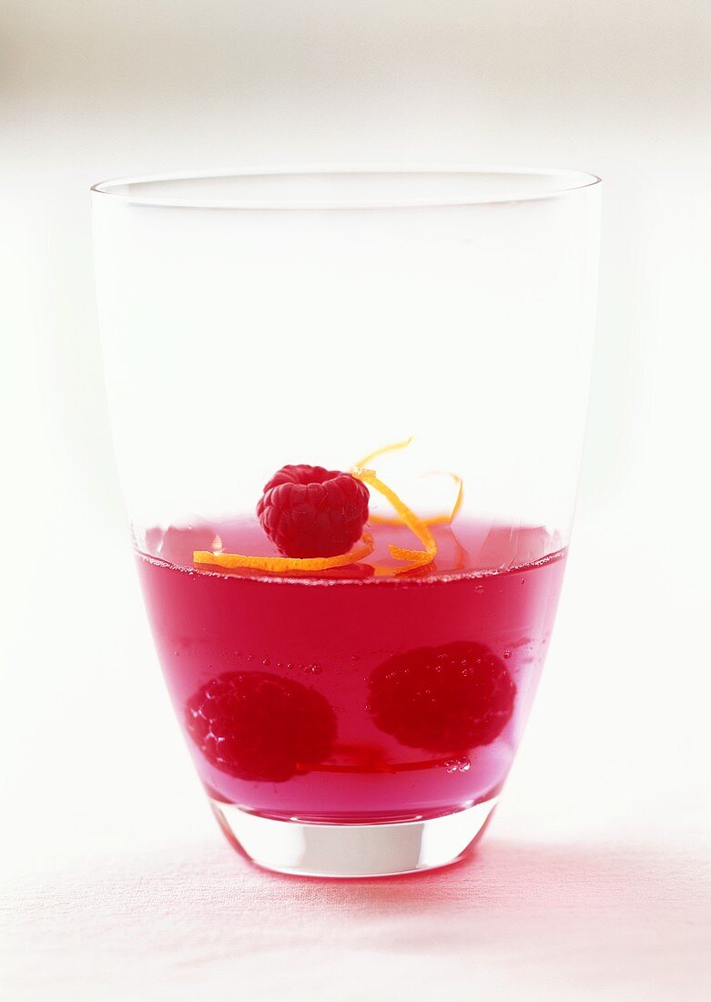 Red jelly with raspberries in glass