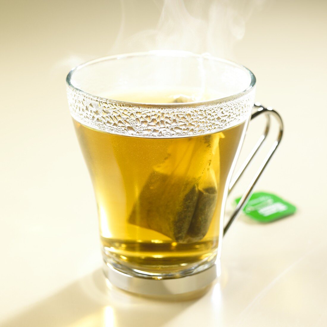 Hot peppermint tea with tea bag in glass