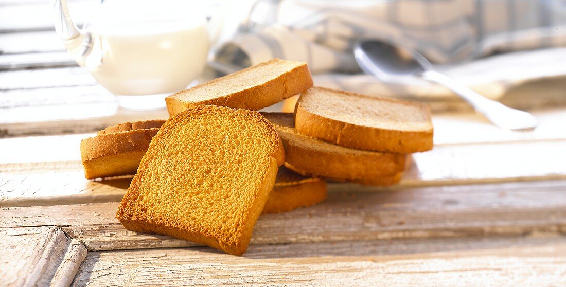 Zwieback (rusk) in front of milk jug