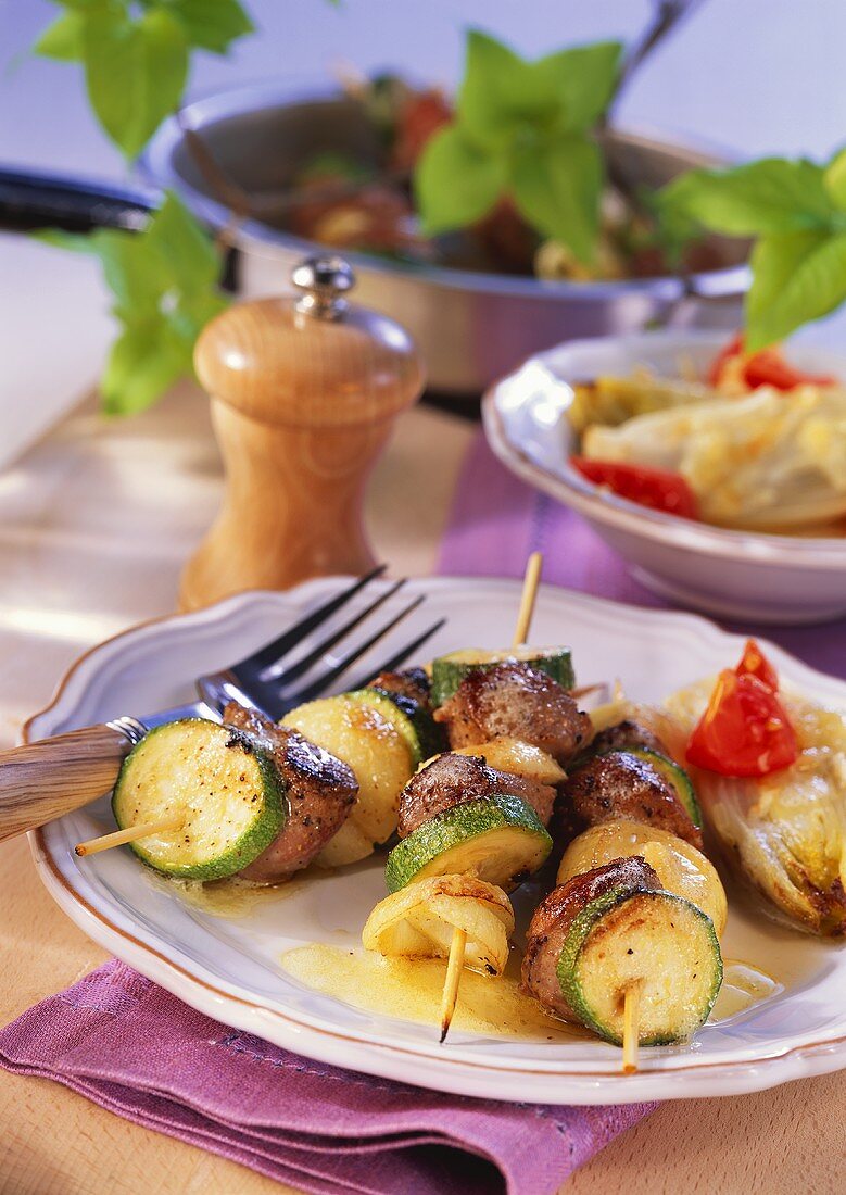 Grilled lamb and courgette kebabs with baked chicory