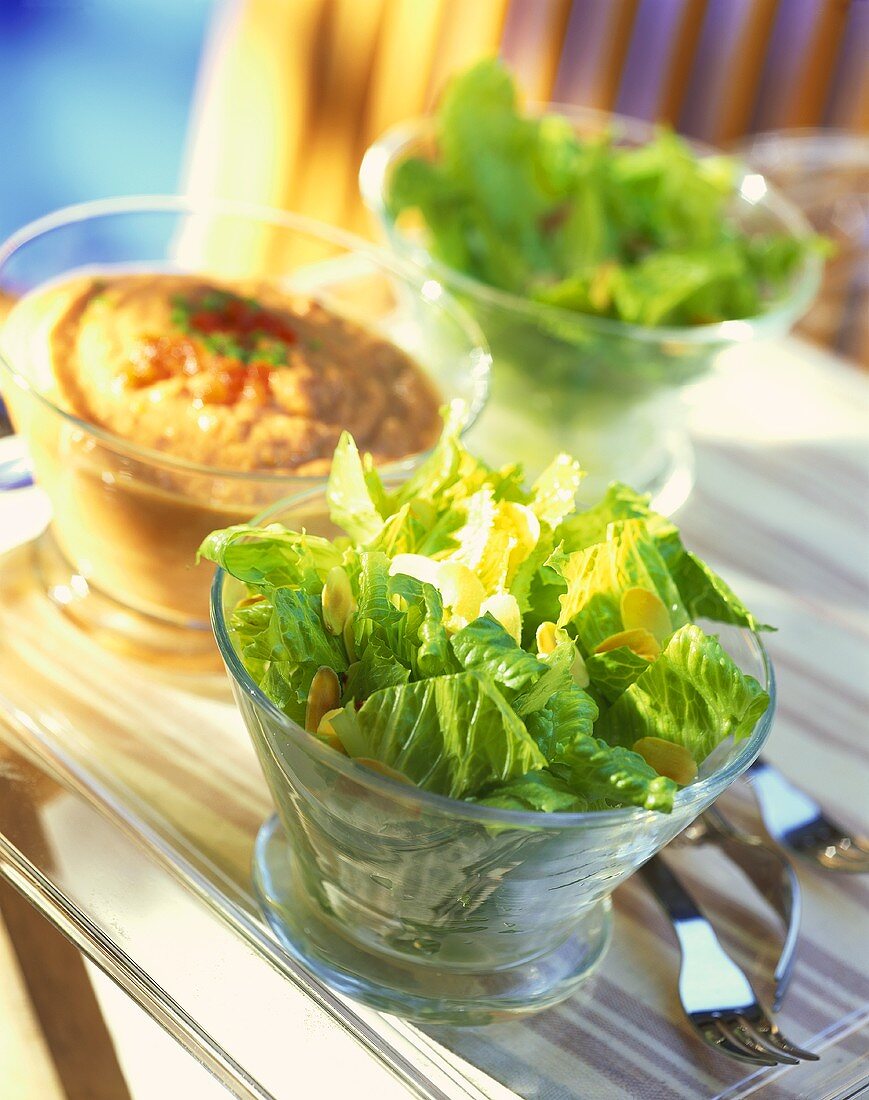 Salad leaves with flaked almonds and tomato dip