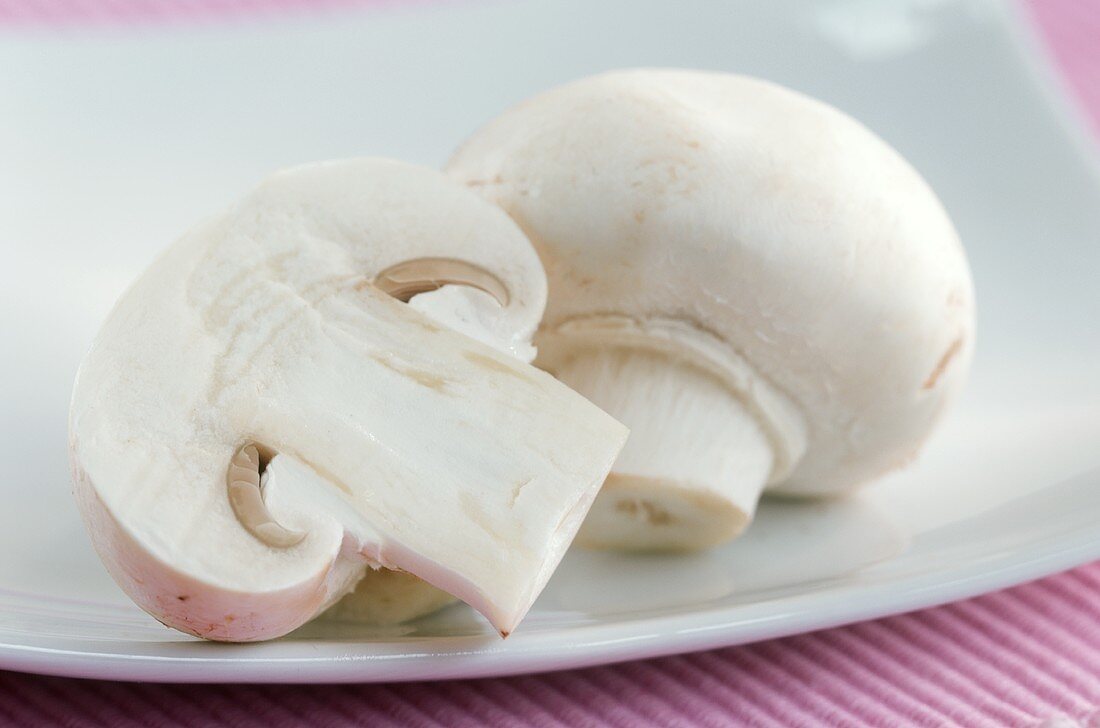 Whole and half mushroom on plate