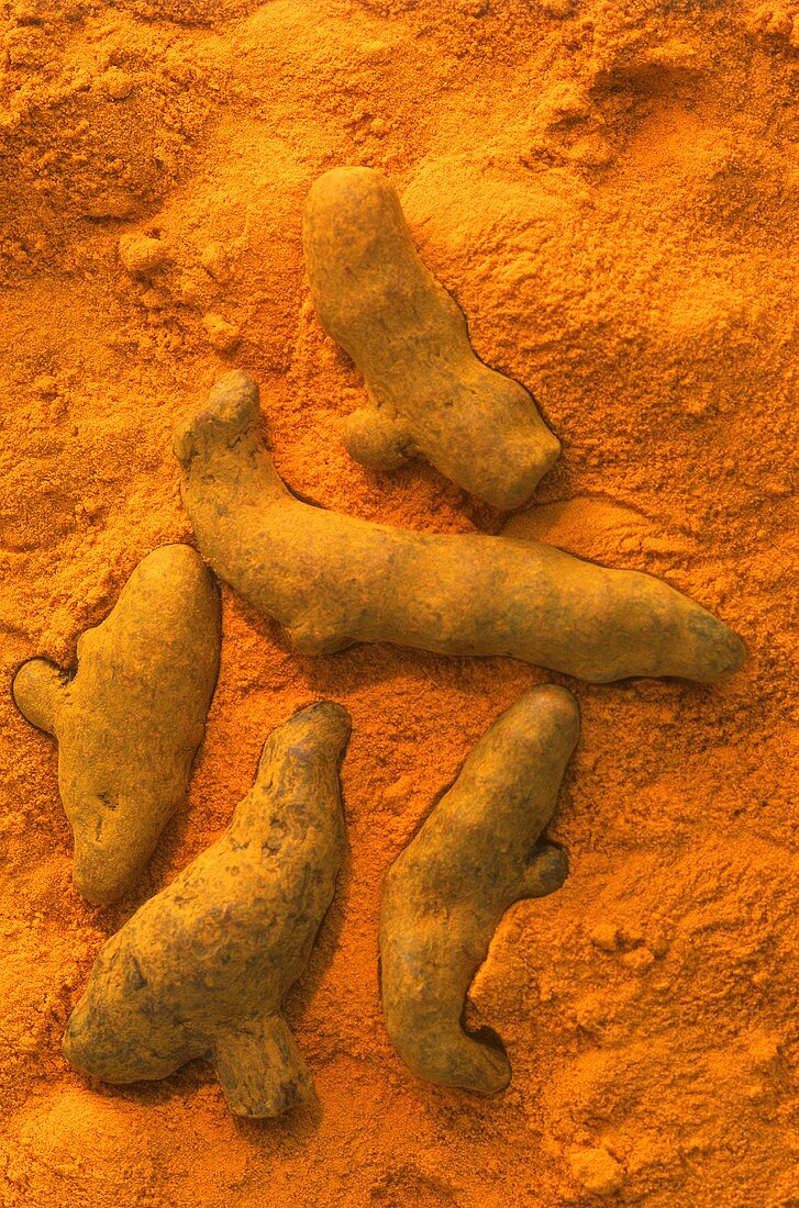 Turmeric roots on ground turmeric (filling the picture)