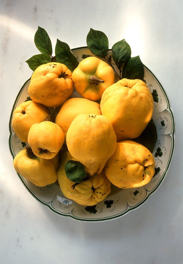 Fresh quinces on plate