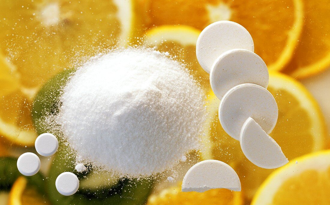 Vitamin c tablets and powder on citrus fruits