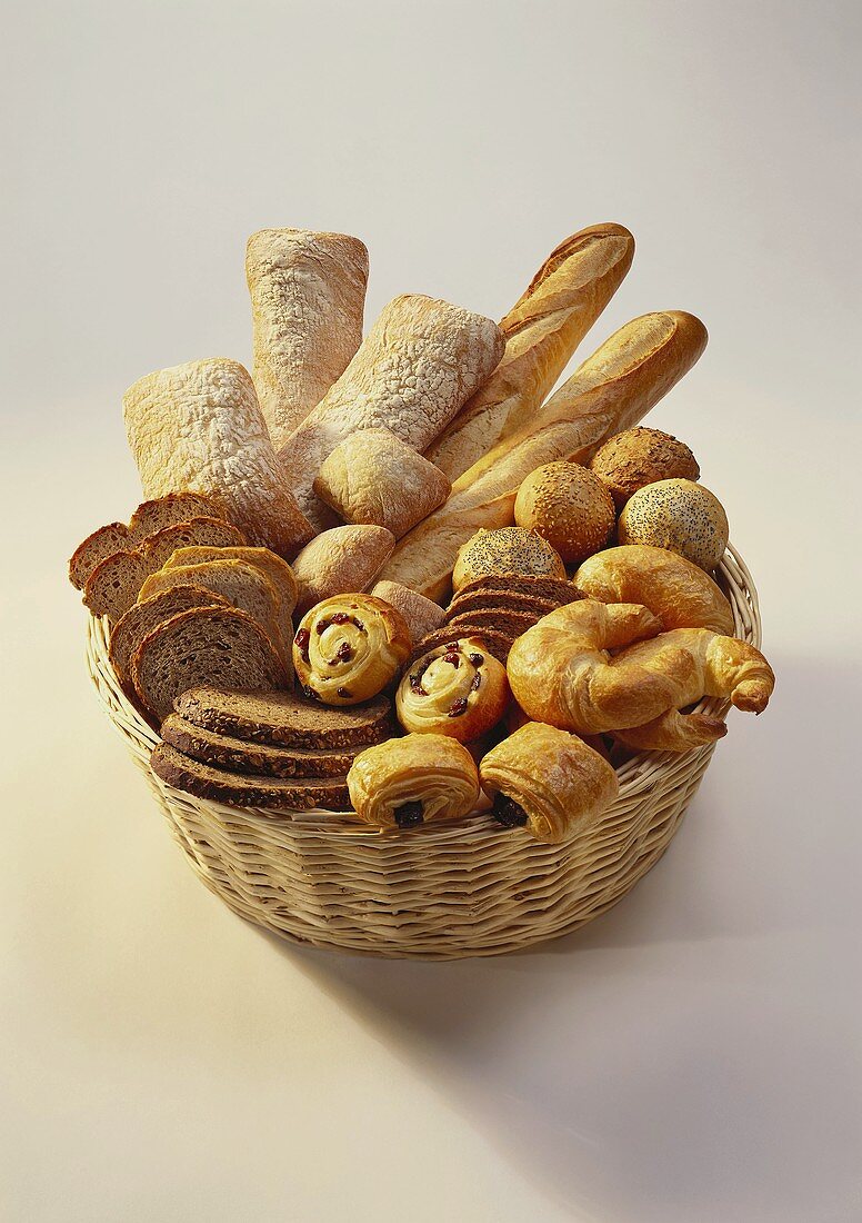 Loaves, bread rolls and sweet baked goods in bread basket