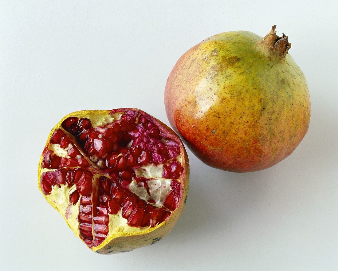 Whole and half pomegranate