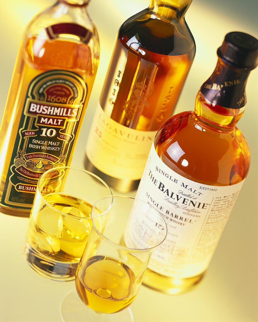 Various types of whiskey in bottles and glasses