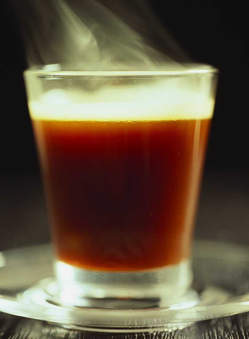 Steaming coffee in glass