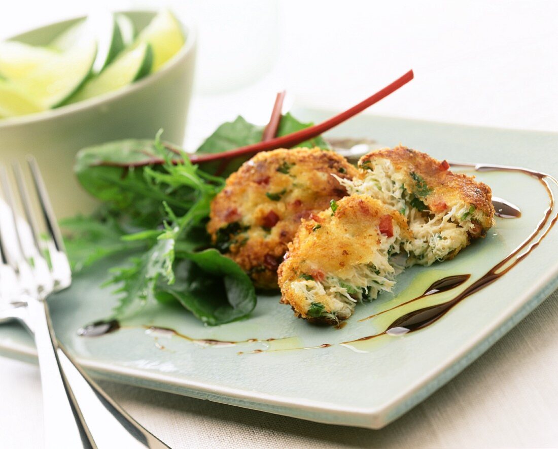 Fish cakes with salad, wedge of lime