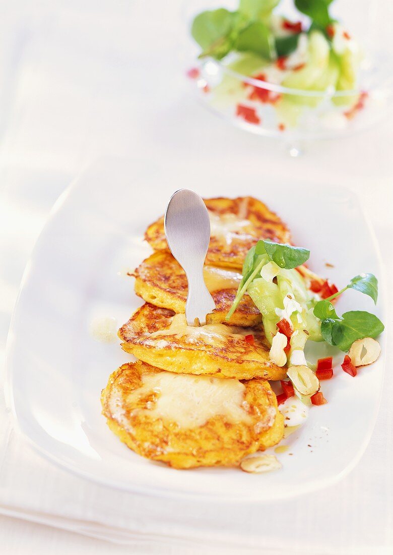 Cheese and sweetcorn cakes with cucumber salad