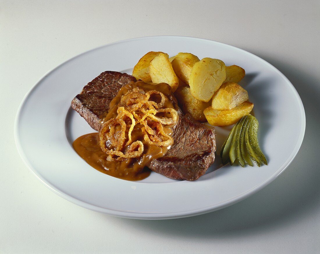 Beefsteak with potatoes and onion sauce
