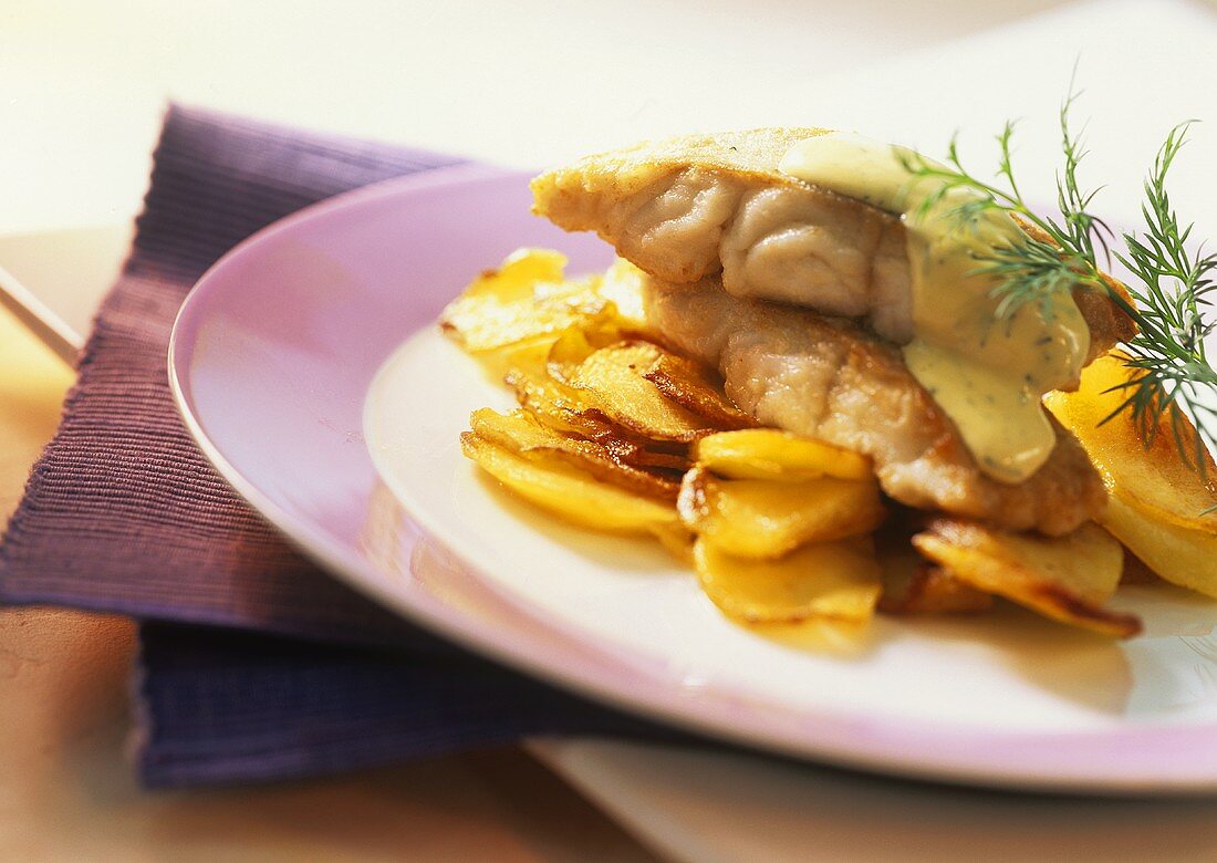 Fish fillet with mustard and dill sauce and fried potatoes