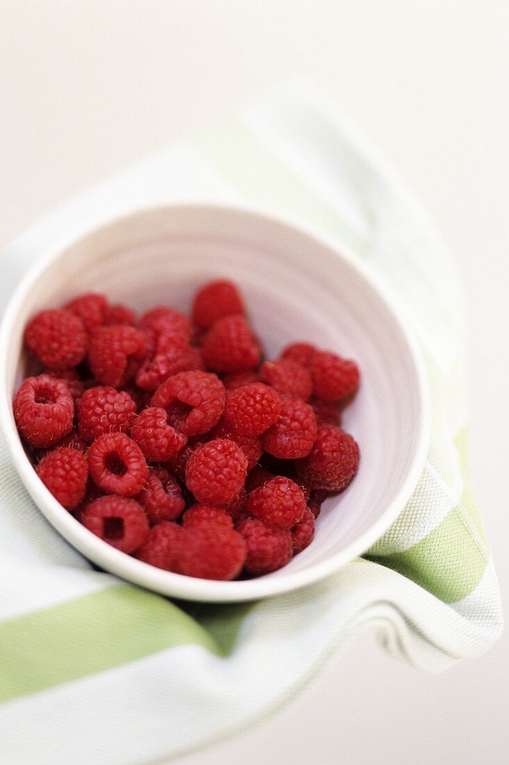 Fresh raspberries in small bowl