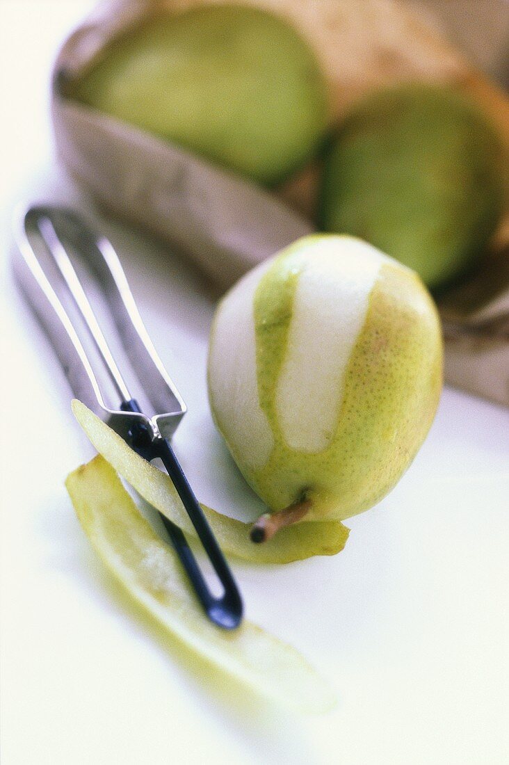 Green pear, partly peeled