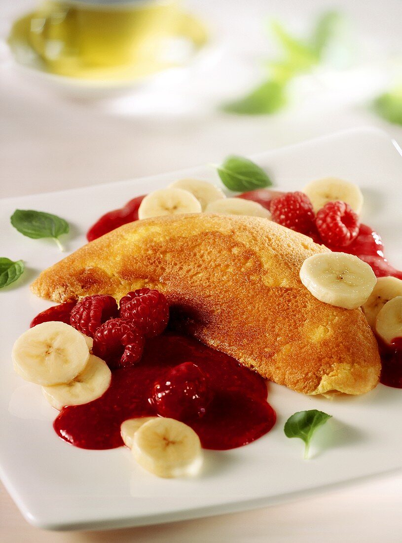 Soufflé omelette with raspberries and bananas