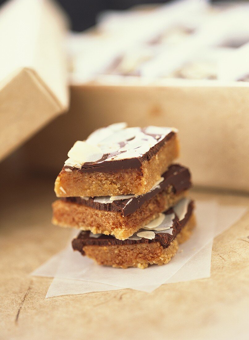 Caramel slices with chocolate and flaked almonds