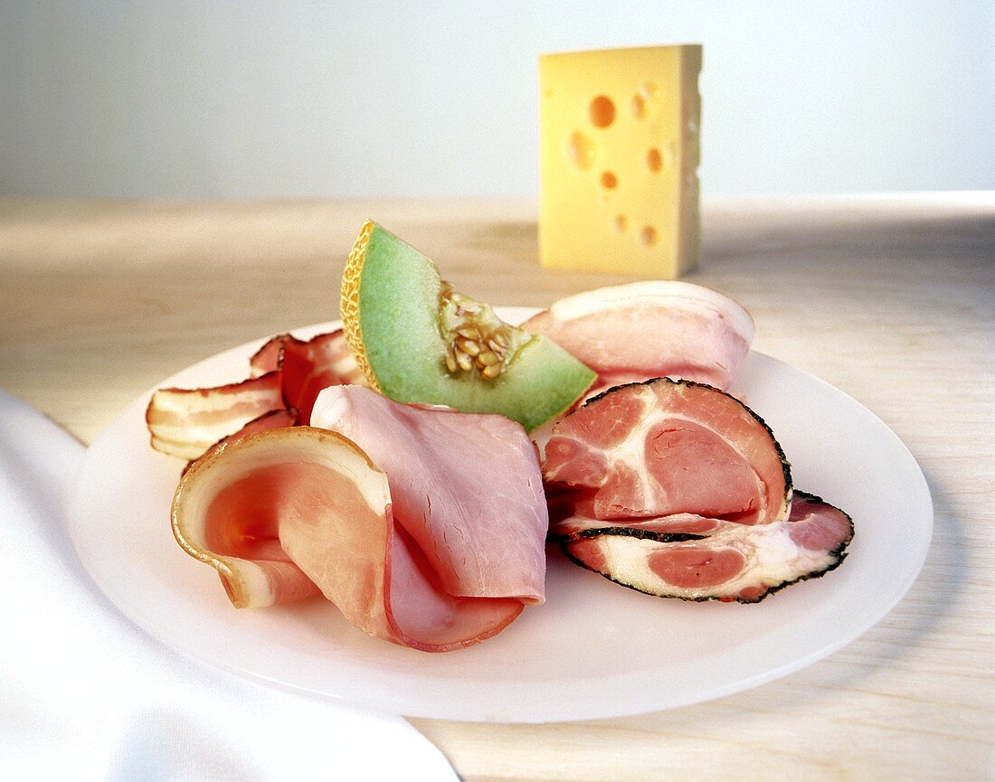 Platter of ham with sweet melon; cheese