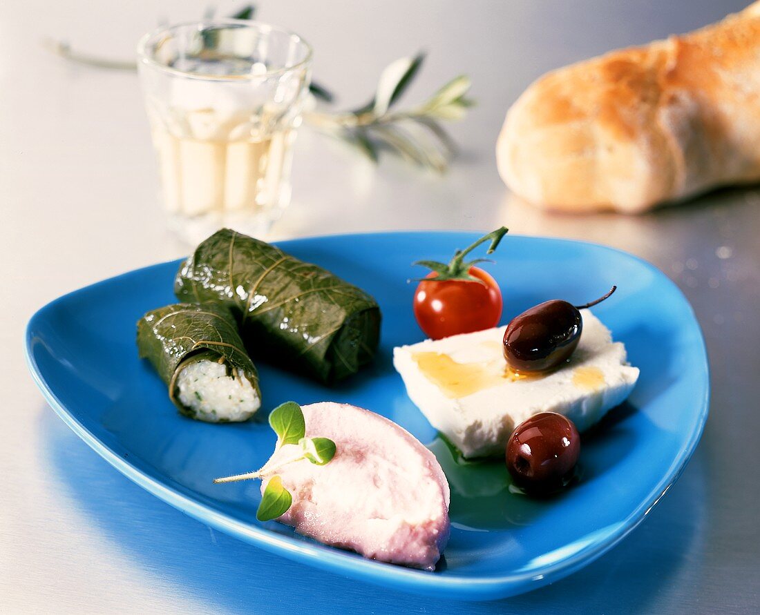 Greek appetiser plate with stuffed vine leaves etc.
