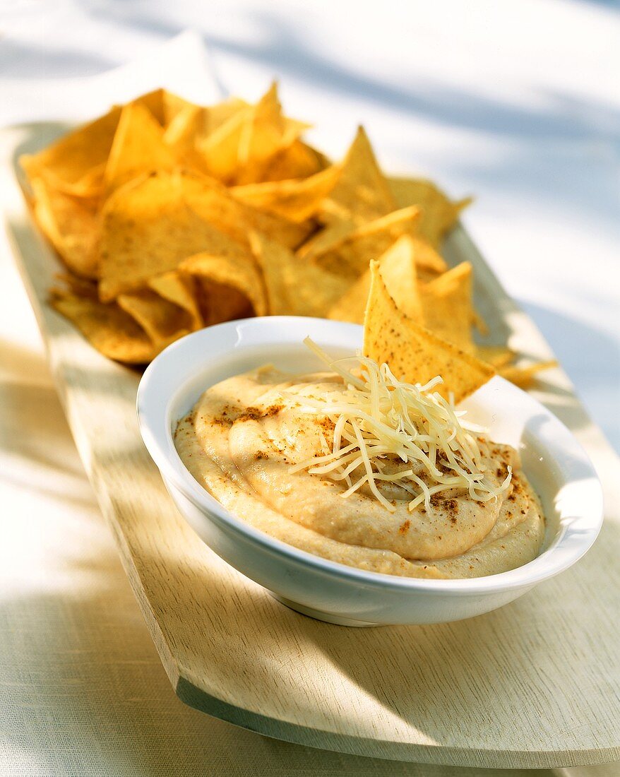 Hummus with grated cheese and tortilla chips