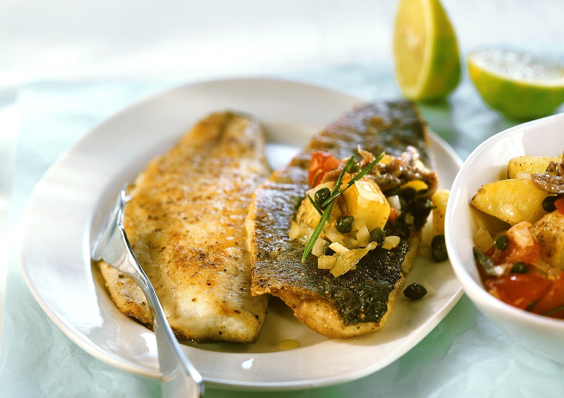 Wolf-fish with potatoes, tomatoes and capers
