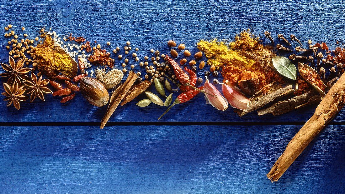 Various spices on blue painted wood