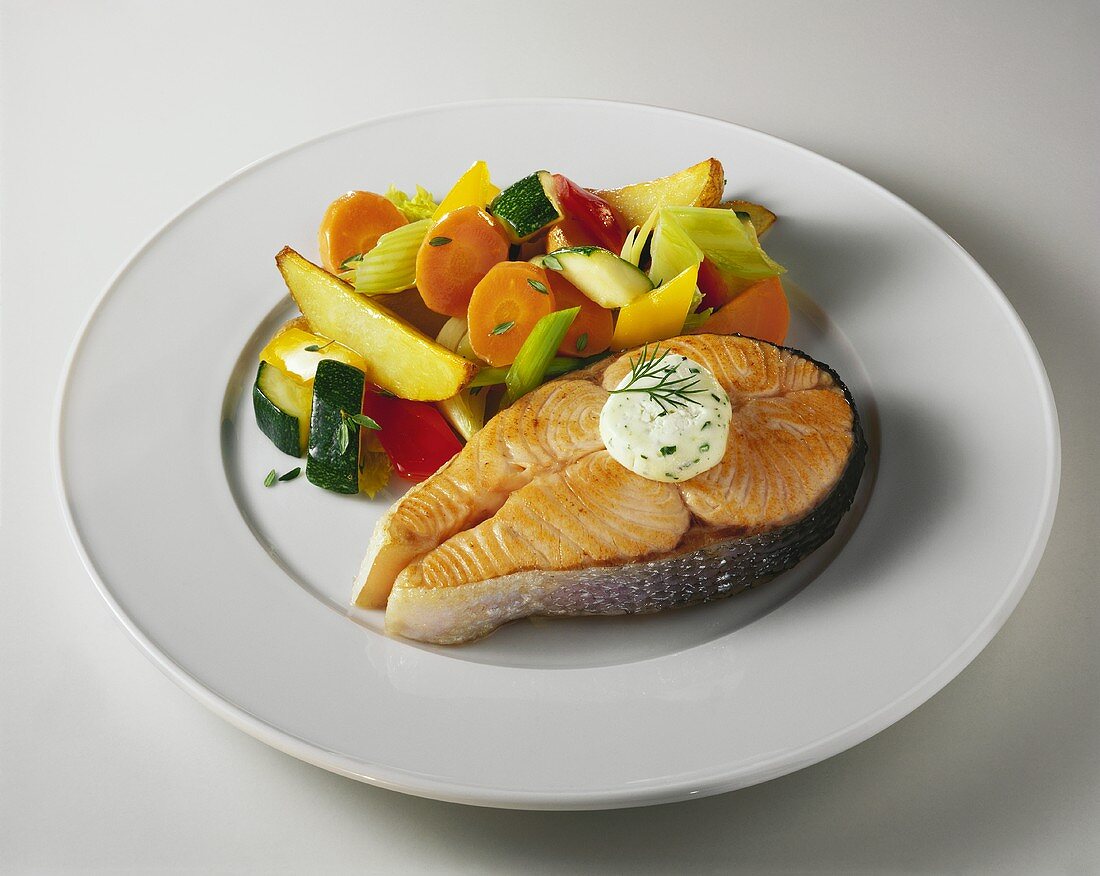 Salmon steak with vegetables and herb butter