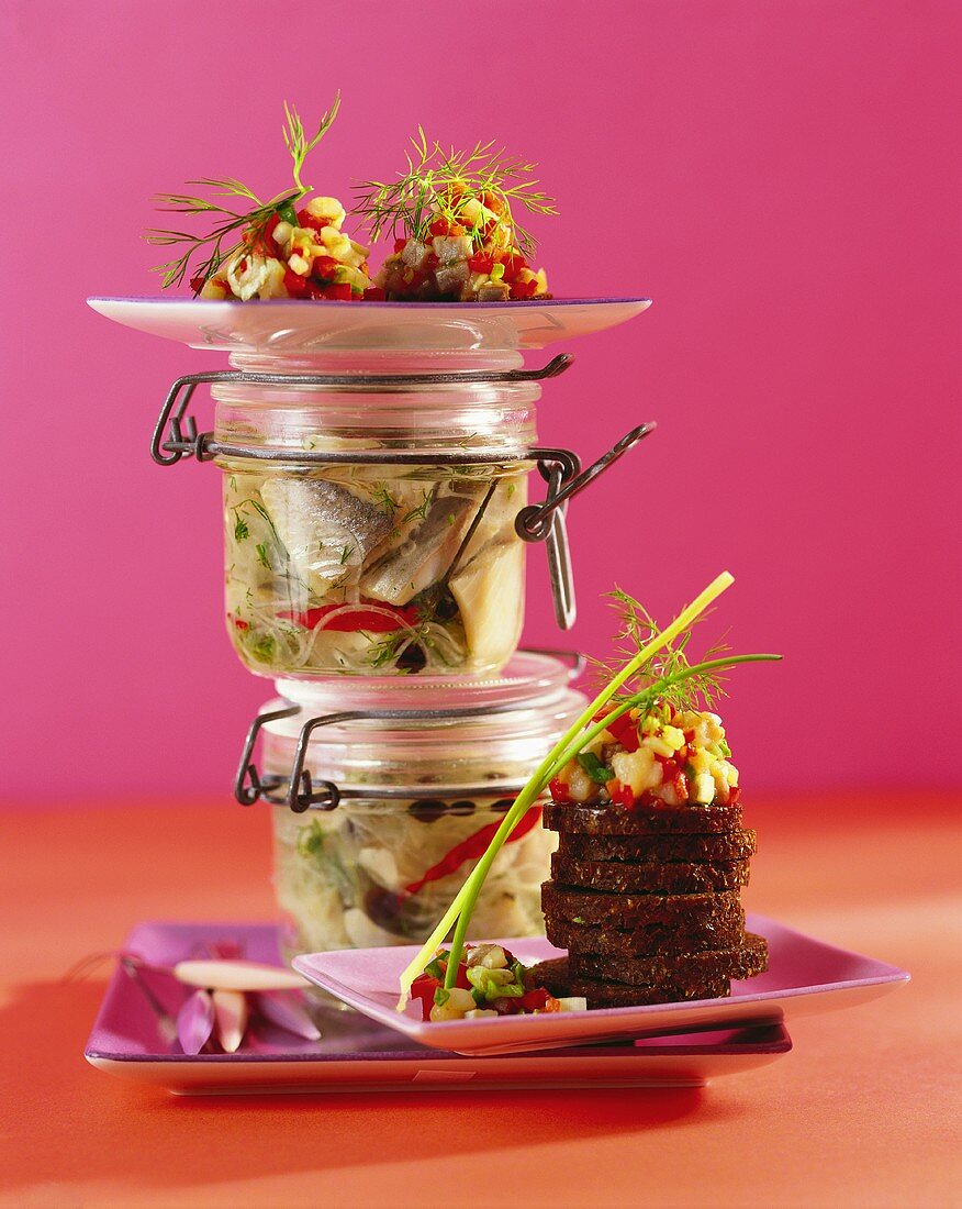 Herring salad in preserving jars and on pumpernickel