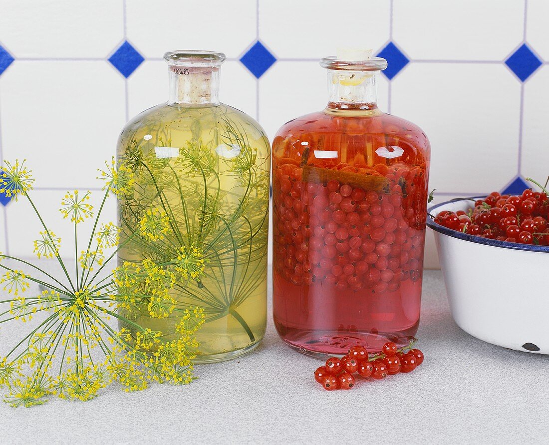 Blackcurrant liqueur and herb oil with dill in kitchen