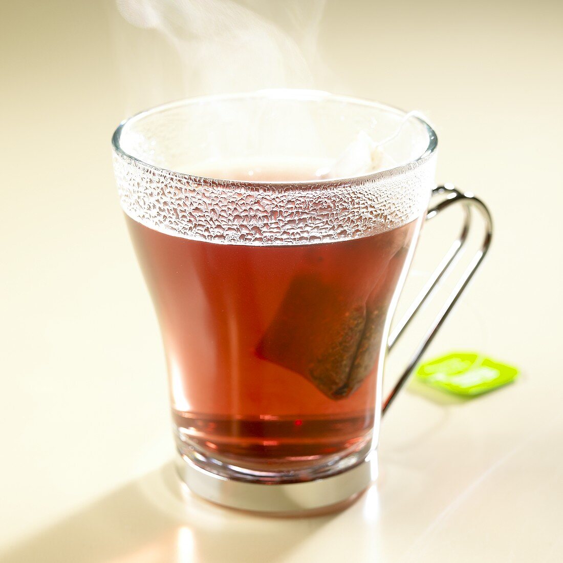 Hot herb tea with tea bag in glass