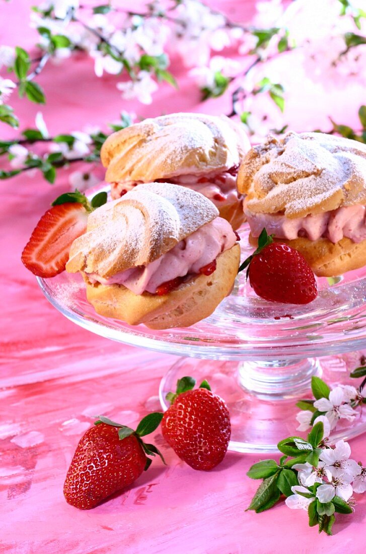 Cream puffs with strawberry cream on cake plate