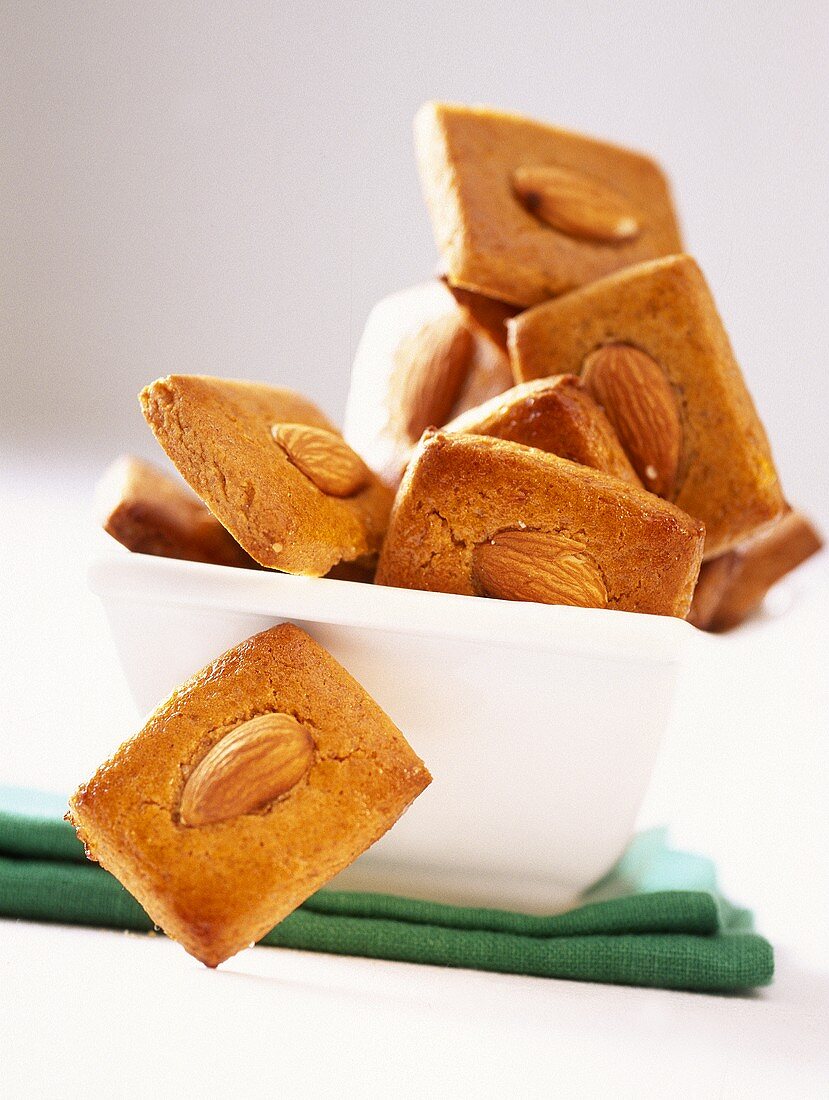 Rectangular almond biscuits in white bowl