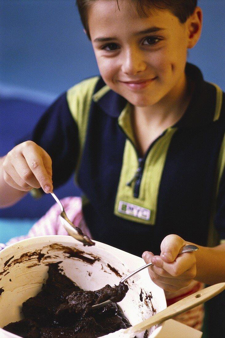 Small boy making chocolate biscuits