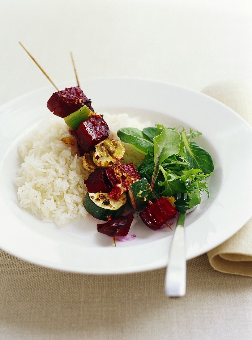 Vegetable kebabs with rice and salad