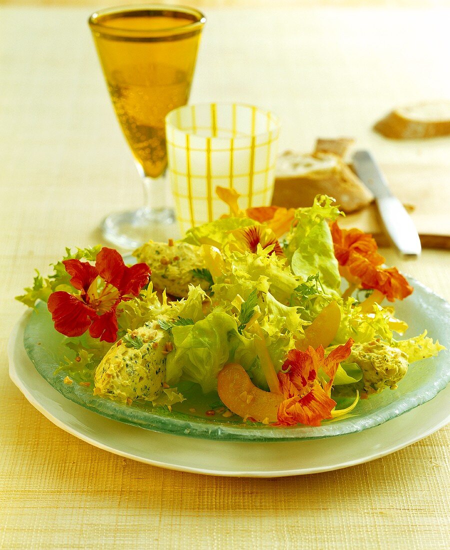 Green salad with soft cheese balls, edible flowers & apricots
