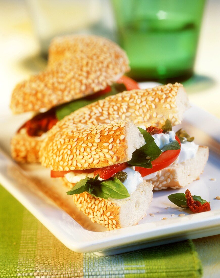 Sesame bagel with soft cheese and tomatoes