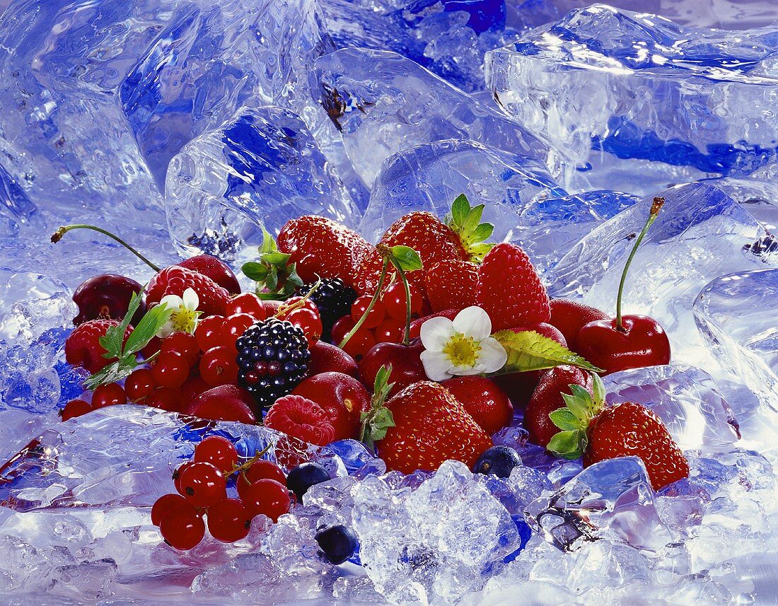 Fresh berries and cherries on ice