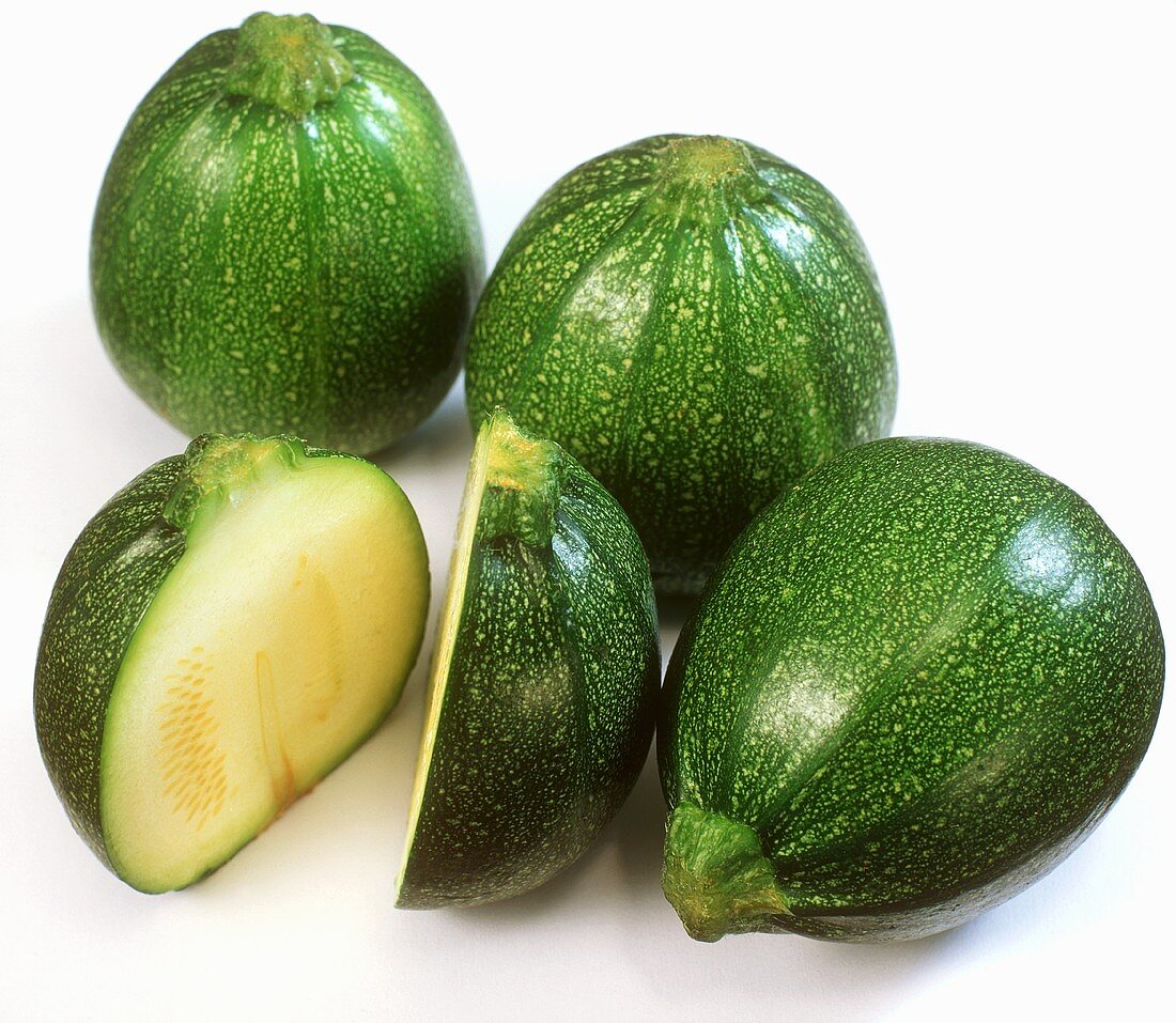 Round courgettes, one halved