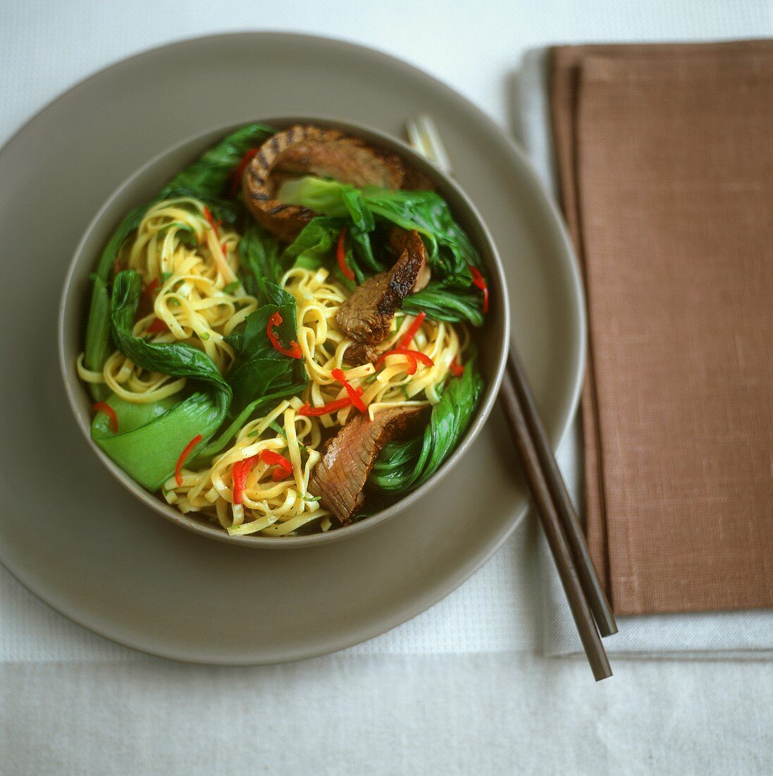 Egg noodles with beef and pak choi