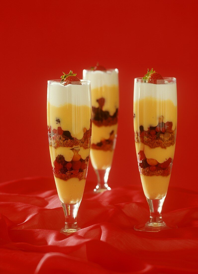 Trifle with vanilla cream, berries & sponge in custard
