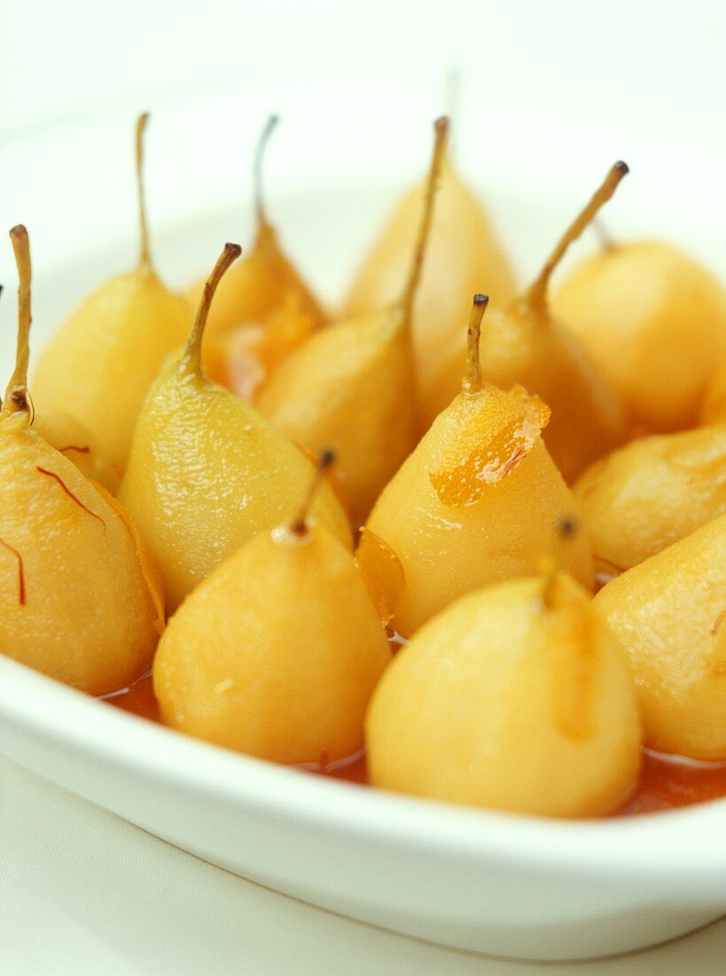 Poached pears in orange sauce