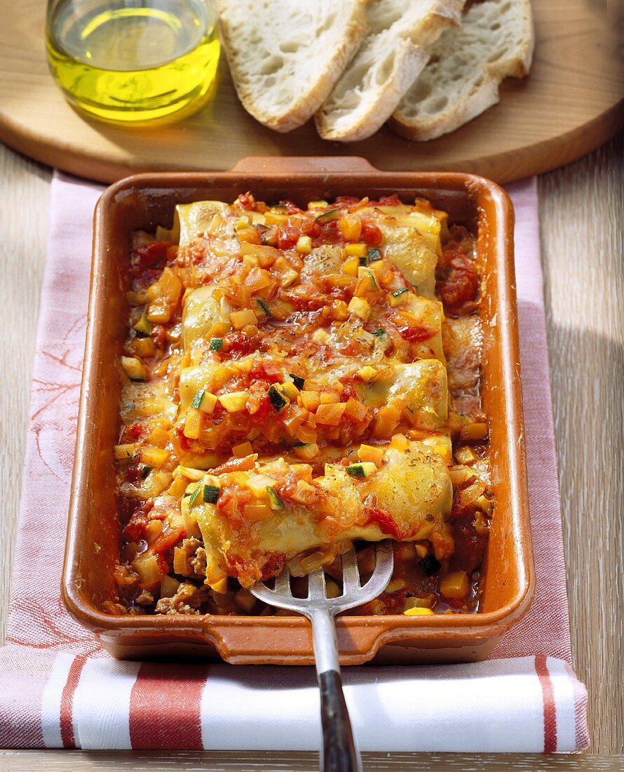 Cannelloni with vegetable sauce in baking dish
