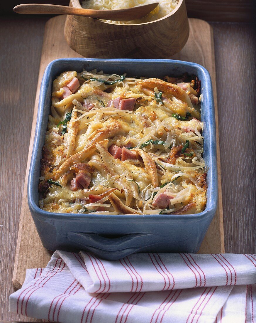 Baked potato noodles with white cabbage and ham